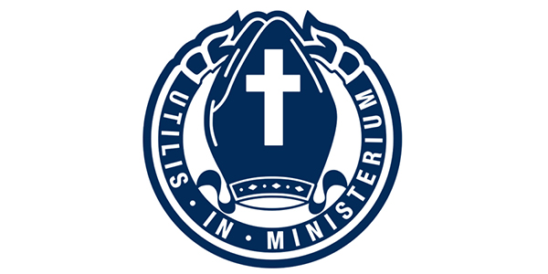 Logo of Camberwell Grammar School featuring a pair of hands holding a cross, surrounded by the Latin phrase "Utilis in Ministerium" in a circular design.
